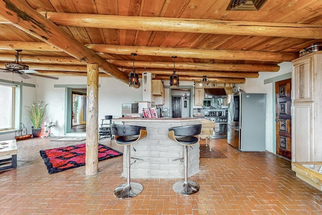 kitchen featuring stainless steel appliances, beamed ceiling, wooden ceiling, and brick floor