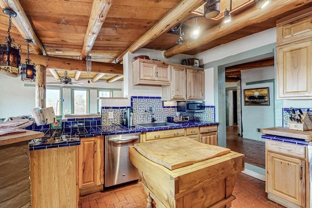 kitchen featuring appliances with stainless steel finishes, beamed ceiling, tile countertops, and decorative backsplash