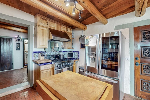 kitchen featuring wooden ceiling, brick floor, appliances with stainless steel finishes, ventilation hood, and beam ceiling