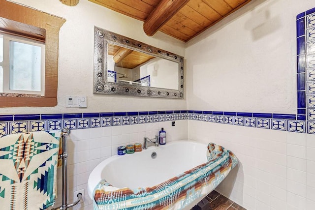 bathroom with wainscoting, wooden ceiling, beam ceiling, and tile walls