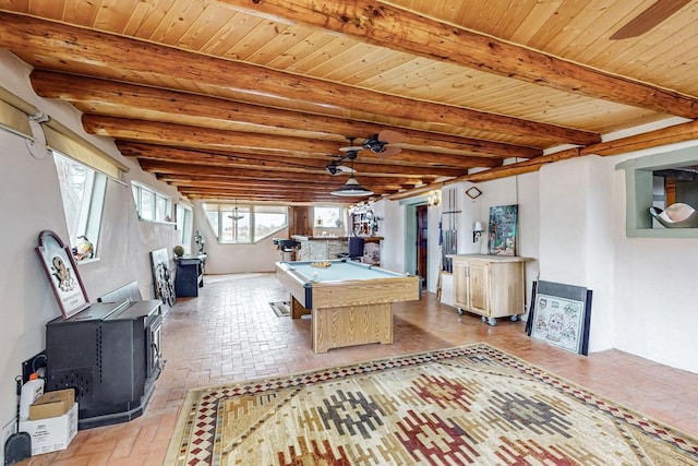 recreation room featuring wooden ceiling, brick floor, billiards, beamed ceiling, and a wood stove