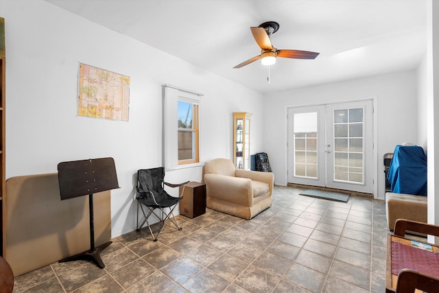 sitting room featuring ceiling fan and french doors