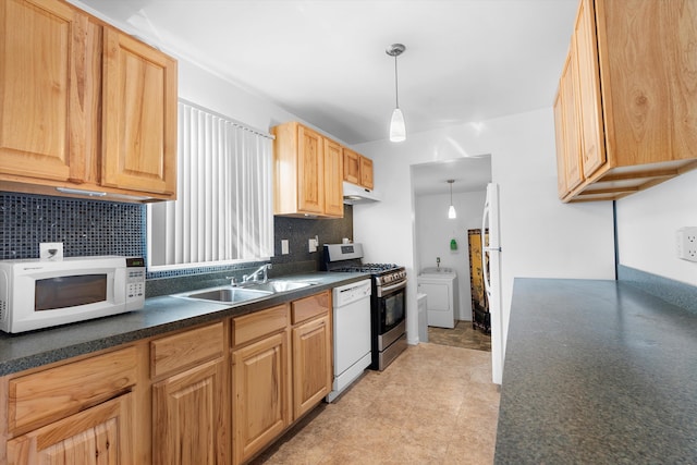 kitchen with tasteful backsplash, washer / dryer, sink, hanging light fixtures, and white appliances