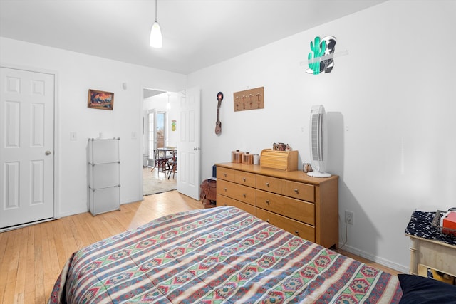 bedroom with light wood-type flooring and white fridge