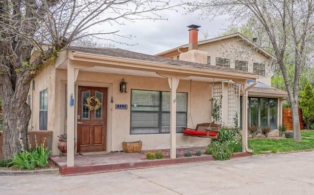 view of exterior entry with covered porch