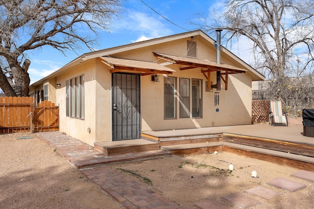 rear view of house featuring a patio