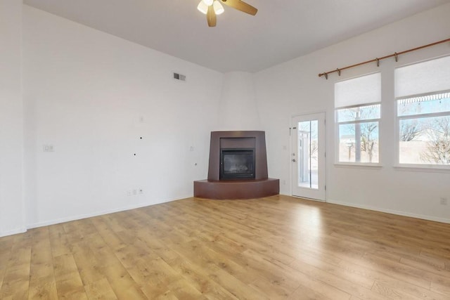 unfurnished living room featuring light hardwood / wood-style flooring and ceiling fan