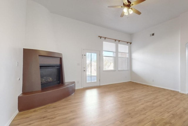 unfurnished living room with ceiling fan and light hardwood / wood-style flooring