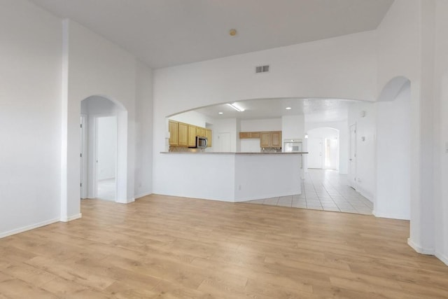 unfurnished living room with light hardwood / wood-style floors