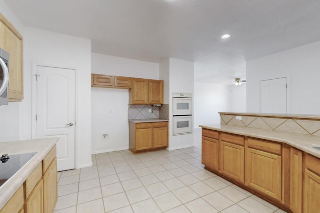 kitchen featuring decorative backsplash, white double oven, ceiling fan, and light tile patterned flooring