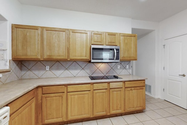 kitchen with black electric stovetop, dishwasher, decorative backsplash, and light tile patterned floors