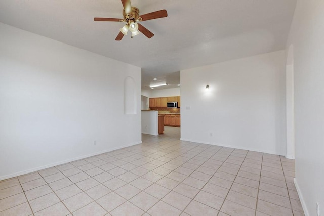 tiled empty room with ceiling fan