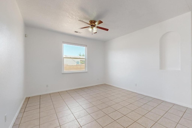 empty room featuring a textured ceiling and ceiling fan