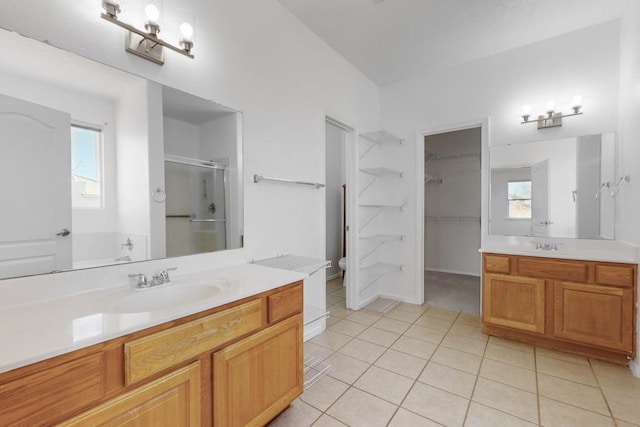 bathroom featuring tile patterned flooring, vanity, toilet, and walk in shower