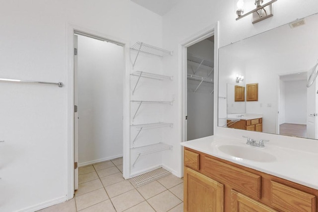 bathroom with tile patterned flooring and vanity