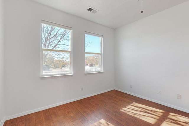 spare room featuring dark hardwood / wood-style flooring