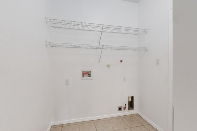 washroom featuring washer hookup, light tile patterned floors, hookup for an electric dryer, and gas dryer hookup