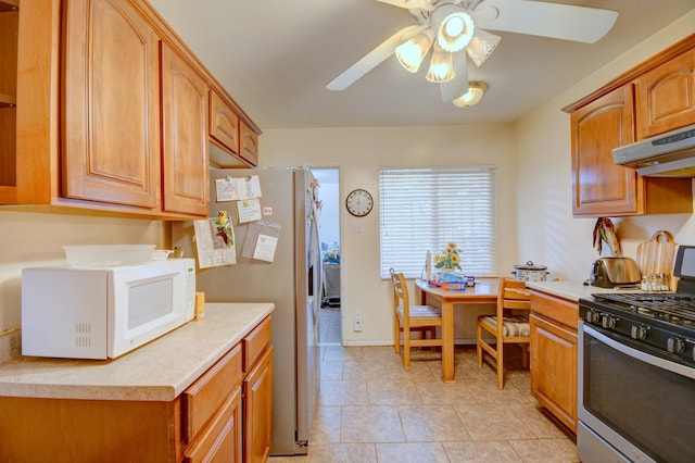 kitchen featuring light tile patterned flooring, ceiling fan, and appliances with stainless steel finishes