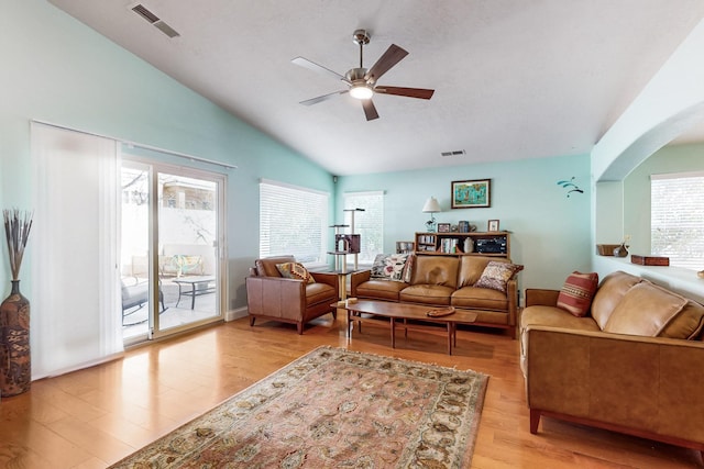 living room with light hardwood / wood-style flooring, vaulted ceiling, and ceiling fan