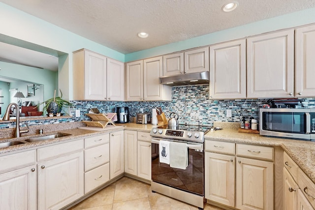 kitchen featuring light tile patterned flooring, appliances with stainless steel finishes, sink, decorative backsplash, and a textured ceiling