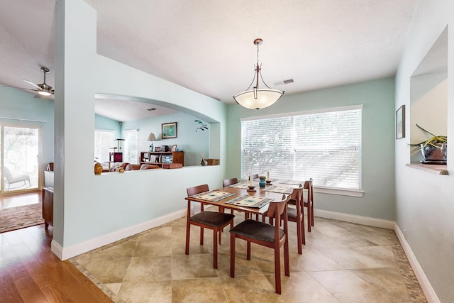 dining area with ceiling fan and light tile patterned floors