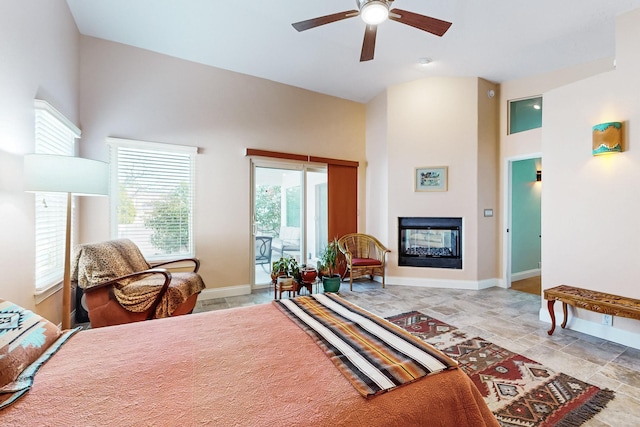 bedroom with ceiling fan, high vaulted ceiling, and access to outside