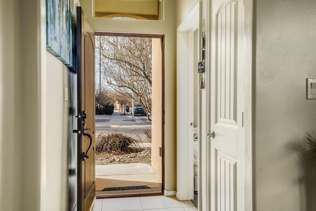 doorway with light tile patterned flooring