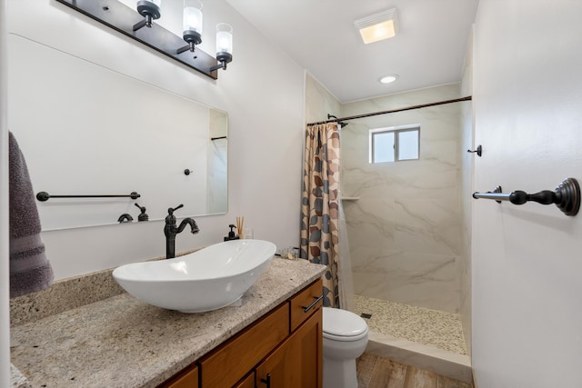 bathroom with walk in shower, vanity, toilet, and hardwood / wood-style floors