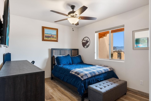 bedroom featuring ceiling fan and light wood-type flooring