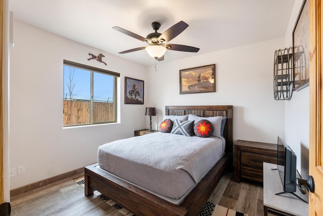 bedroom with hardwood / wood-style flooring and ceiling fan