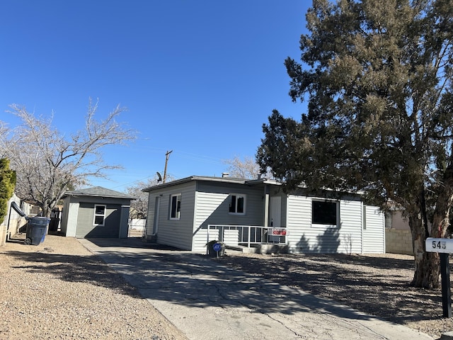 view of front of home with a shed