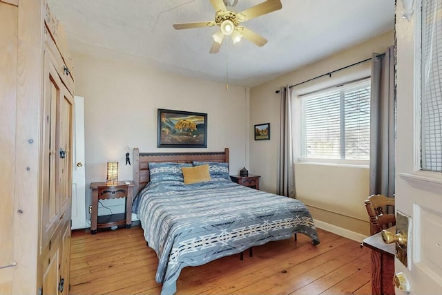 bedroom featuring a closet, ceiling fan, and light hardwood / wood-style flooring