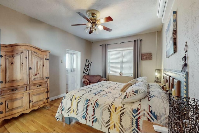 bedroom with ceiling fan and light wood-type flooring