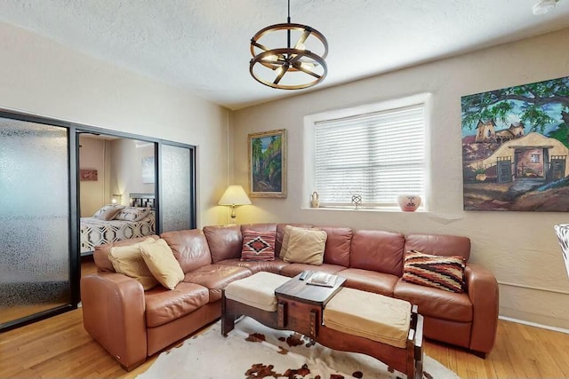 living room with light hardwood / wood-style floors and a textured ceiling