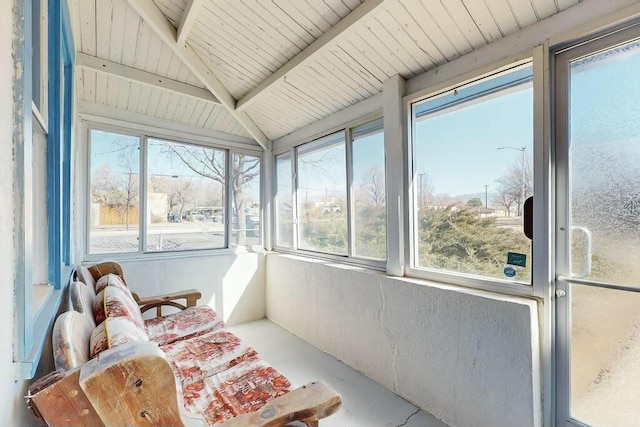 sunroom featuring vaulted ceiling with beams and wood ceiling