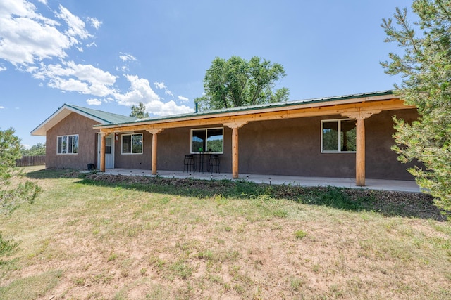 view of front of house with a front lawn and a patio area