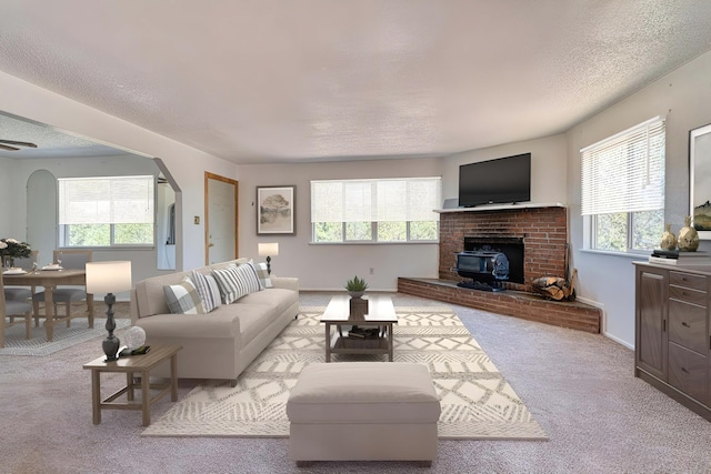 carpeted living room featuring a textured ceiling