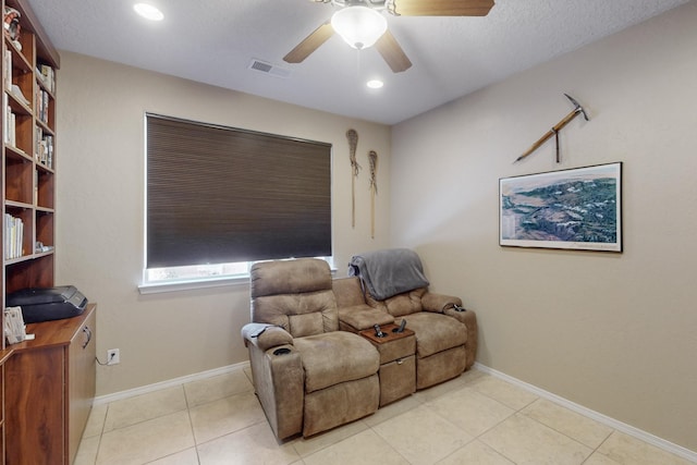 sitting room with light tile patterned flooring and ceiling fan