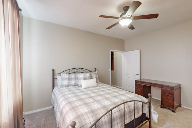 bedroom with ceiling fan and light carpet