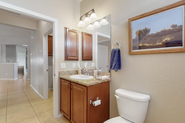 bathroom featuring tile patterned flooring, vanity, and toilet