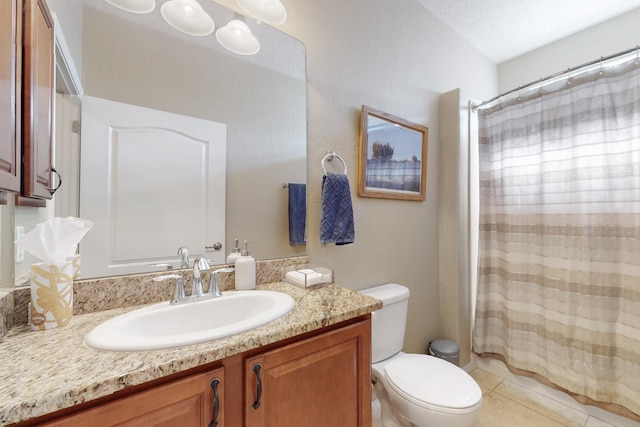 bathroom featuring vanity, a textured ceiling, tile patterned floors, and toilet