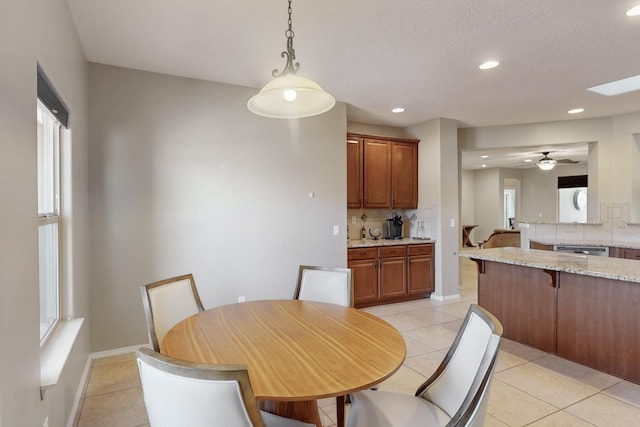 tiled dining room featuring ceiling fan