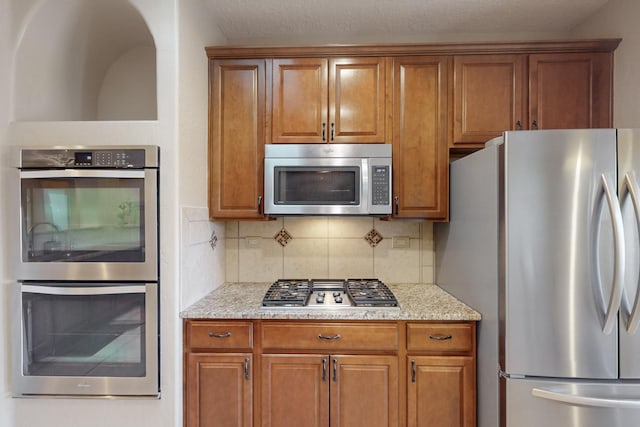 kitchen featuring tasteful backsplash and appliances with stainless steel finishes