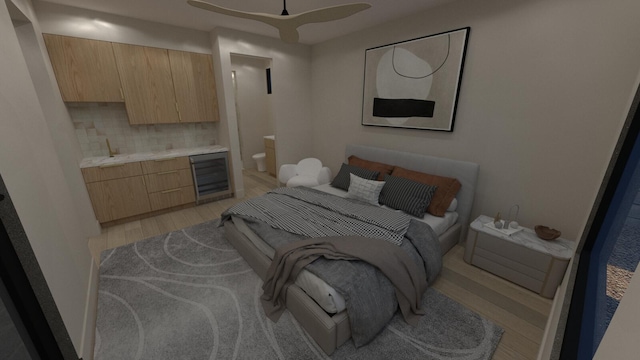 bedroom with ensuite bath, light hardwood / wood-style floors, and beverage cooler