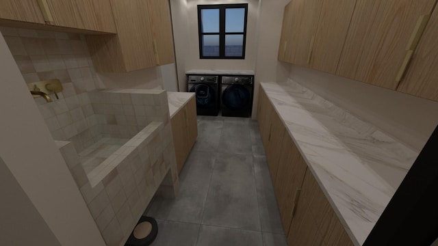 bathroom with separate washer and dryer and tile patterned floors