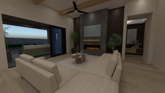 living room featuring beam ceiling, a large fireplace, and light wood-type flooring