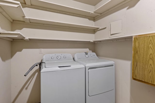 clothes washing area with washing machine and dryer