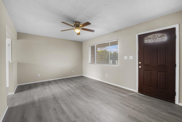 foyer featuring ceiling fan, hardwood / wood-style flooring, and a textured ceiling