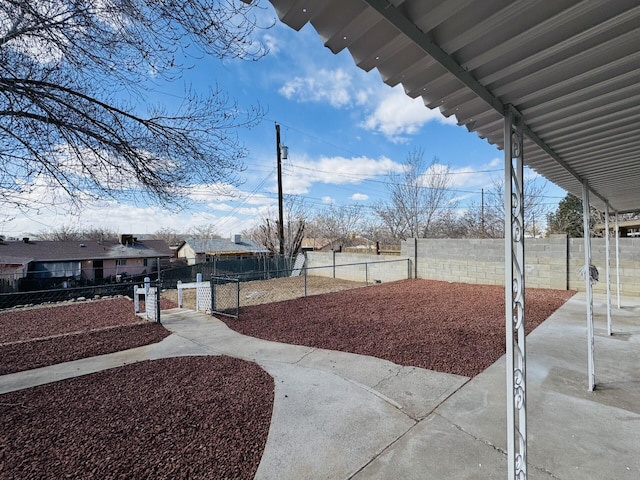 view of yard with a fenced front yard and a gate