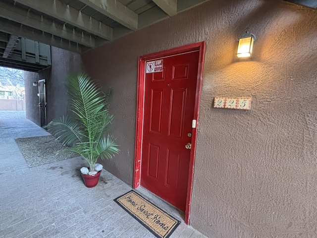 view of exterior entry featuring stucco siding